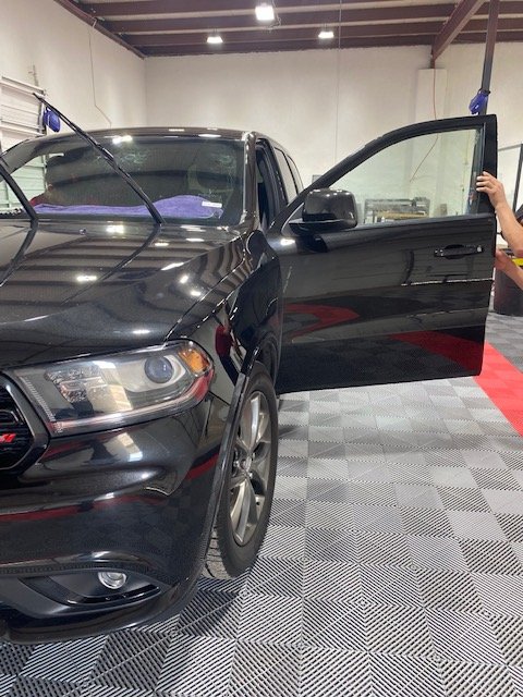 Technician working on a customer vehicle in our shop